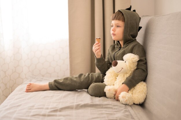 Little boy with tedy bear at home