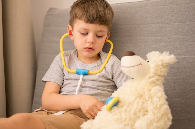 Little boy with tedy bear playing