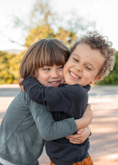 Little boys outdoors hugging