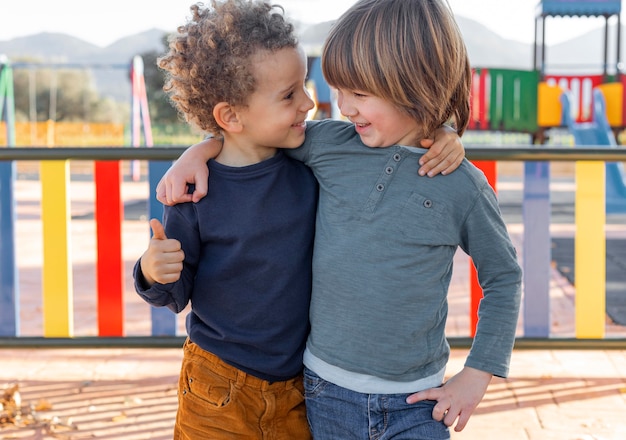 Free photo little boys outdoors hugging