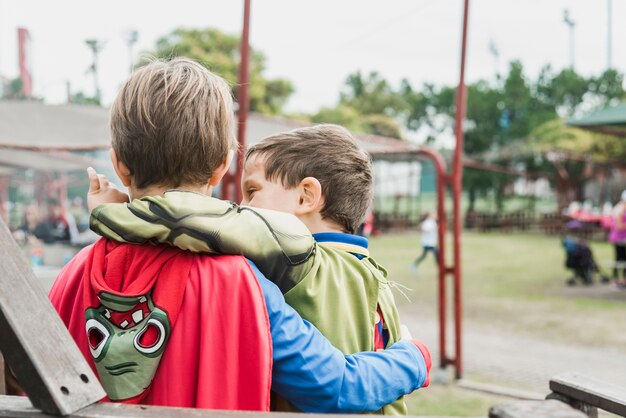 Little brothers standing together on playground