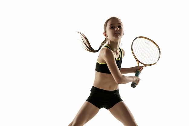 Little caucasian girl playing tennis isolated on white background