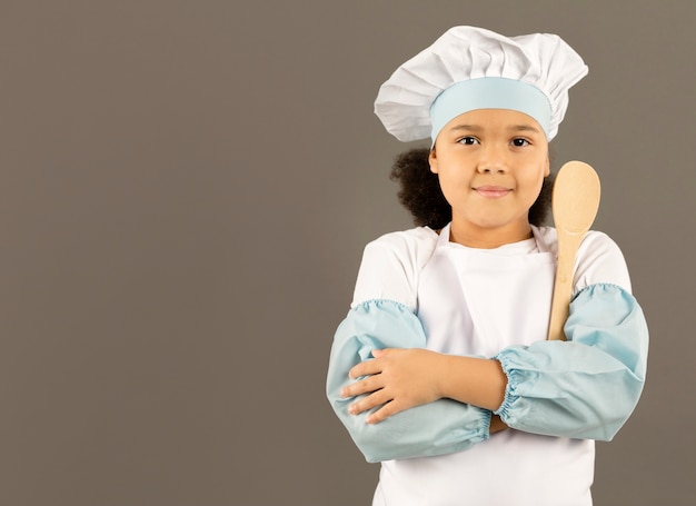 Free photo little chef posing with wooden spoon