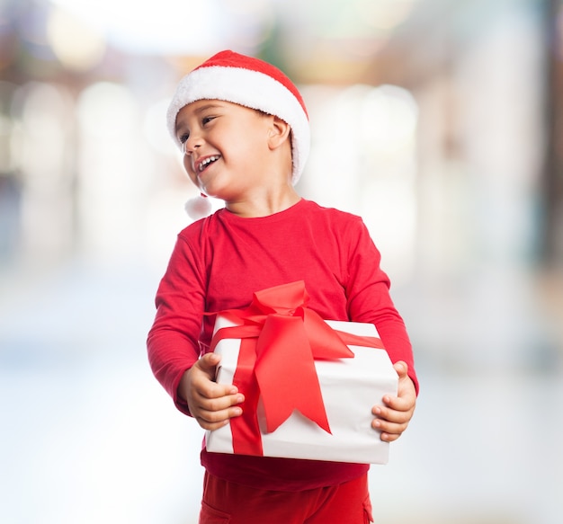 Little child holding a white gift