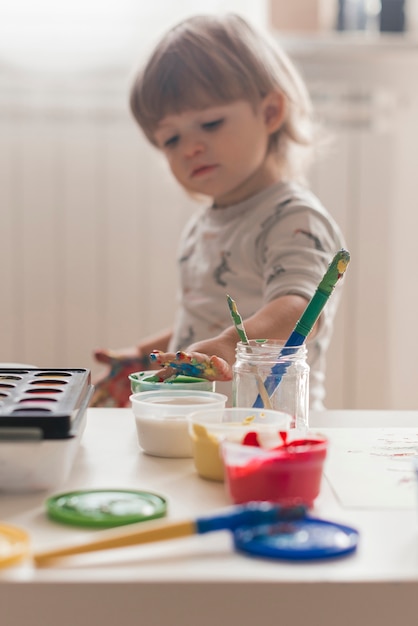 Little child painting like an artist