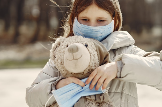 Little child walks outside in a mask