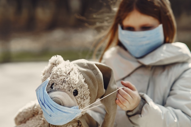 Little child walks outside in a mask