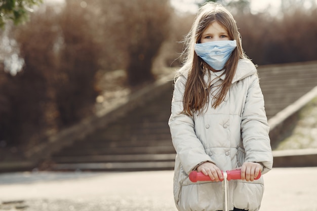 Little child walks outside in a mask