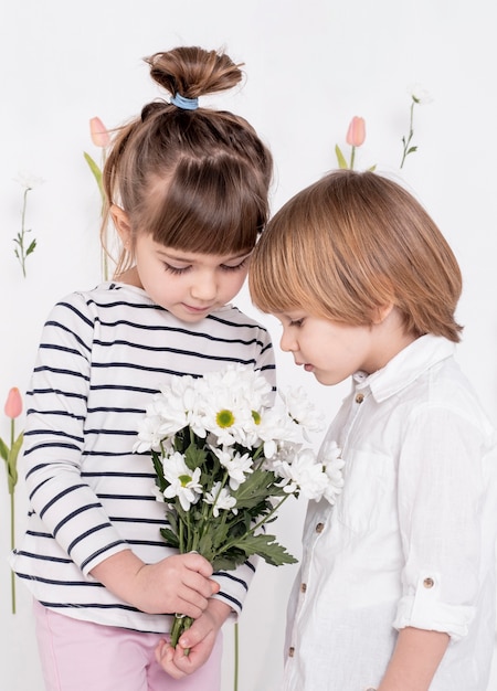 Little children looking at flower bouquet