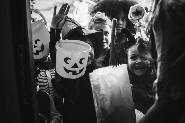 Little children trick or treating on Halloween