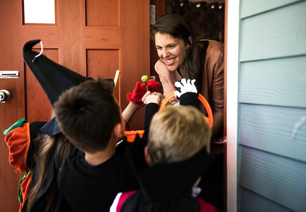 Little children trick or treating on halloween