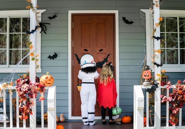 Little children trick or treating on halloween