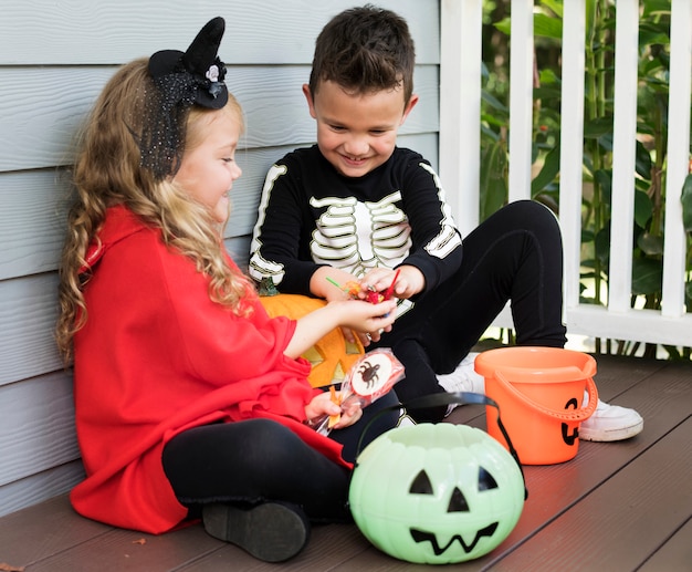 Little children trick or treating on halloween