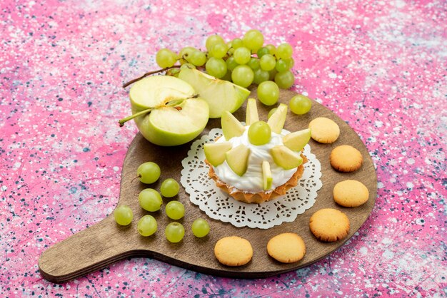 little creamy cake with sliced fruits grapes apples on colored, cake sweet sugar bake