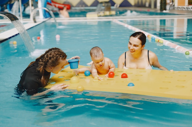 Little cute baby boy. Instructor with kid. Mother with son