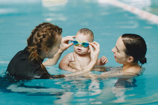 Little cute baby boy. Instructor with kid. Mother with son