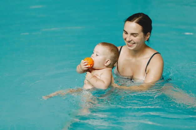 Little cute baby boy. Mother with son. Family playing in a water