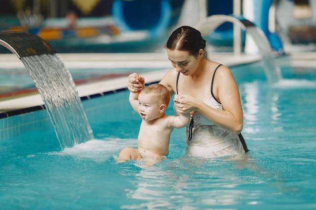 Little cute baby boy. Mother with son. Family playing in a water