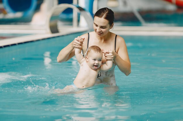 Little cute baby boy. Mother with son. Family playing in a water