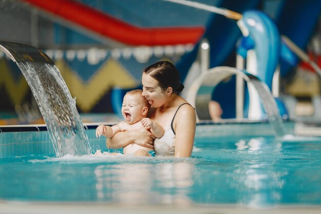 Little cute baby boy. Mother with son. Family playing in a water