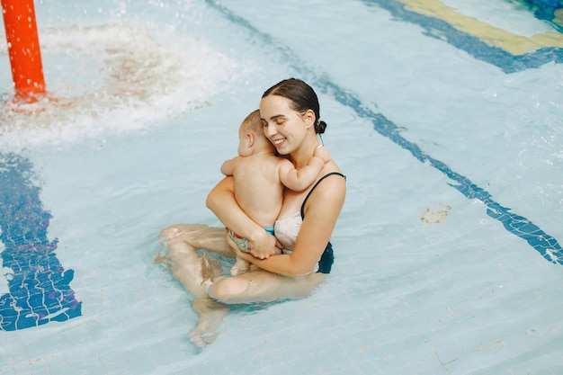 Little cute baby boy. Mother with son. Family playing in a water