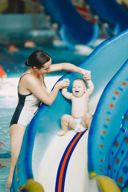 Free photo little cute baby boy. mother with son. family playing in a water