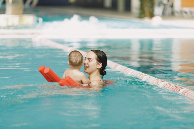 Little cute baby boy. Mother with son. Family playing in a water