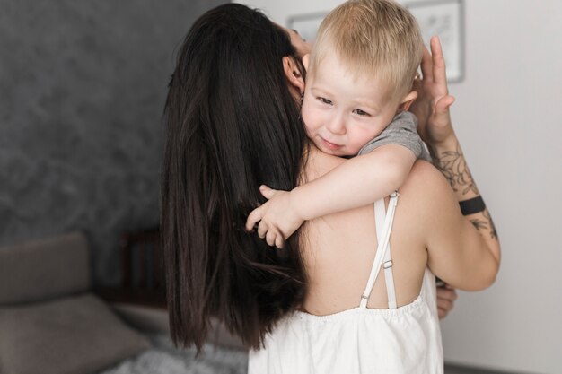 Little cute boy hugging her mother