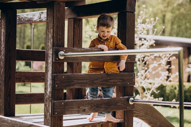 Little cute red hair boy having fun in the backyard