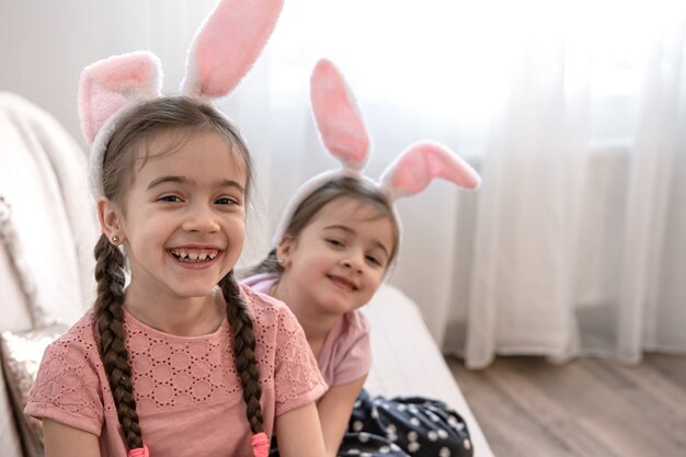 Little cute sisters in bunny ears close up