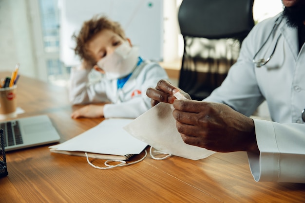 Little doctor during discussing, studying with older colleague