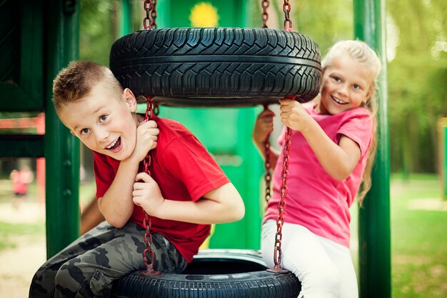 Little girl and boy having fun on playground