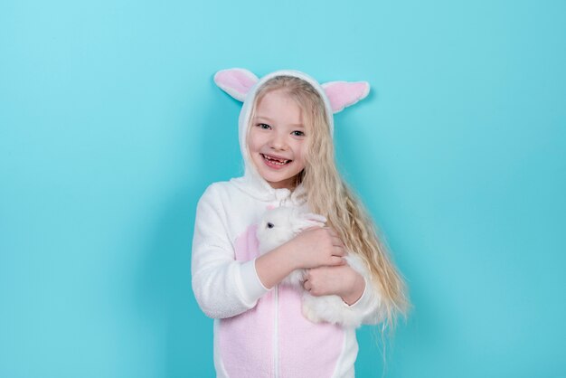 Little girl in bunny ears with rabbit 