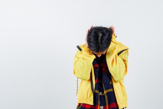 Free photo little girl in checked shirt, jacket covering ears with hands and looking confused , front view.