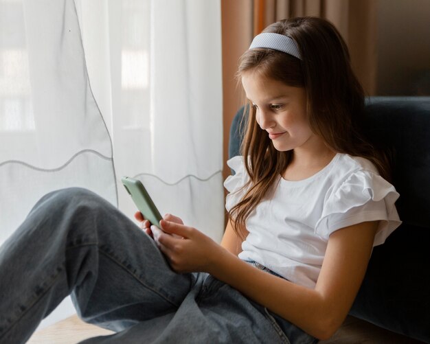 Little girl checking her phone