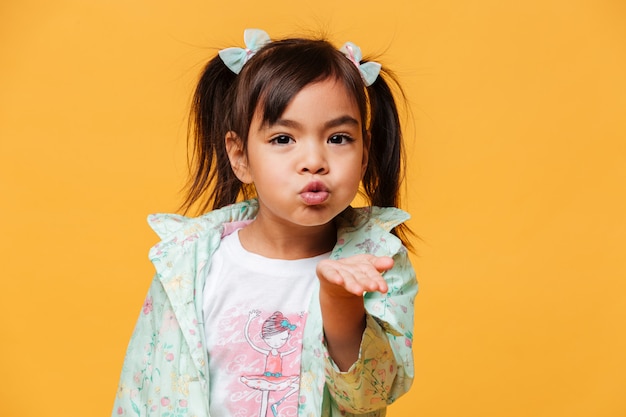 Free photo little girl child blowing kisses.