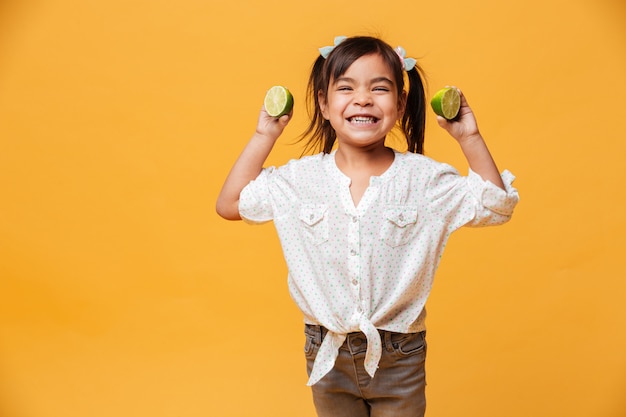 Little girl child holding lime.