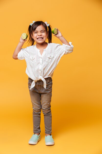 Little girl child holding lime.