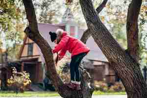 Free photo little girl to climb a tree