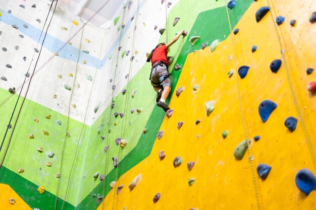 Little girl climbing rock wall