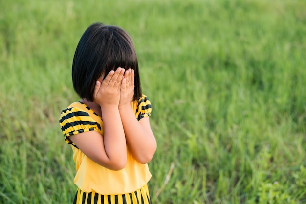 Little girl covering her face