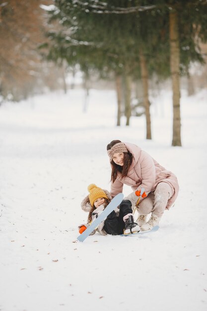 Little girl cross-country skiing with her mother