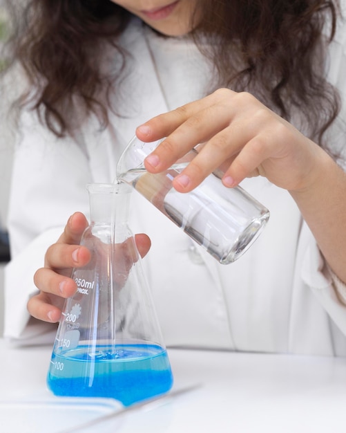 Foto gratuita bambina che fa un esperimento scientifico a scuola