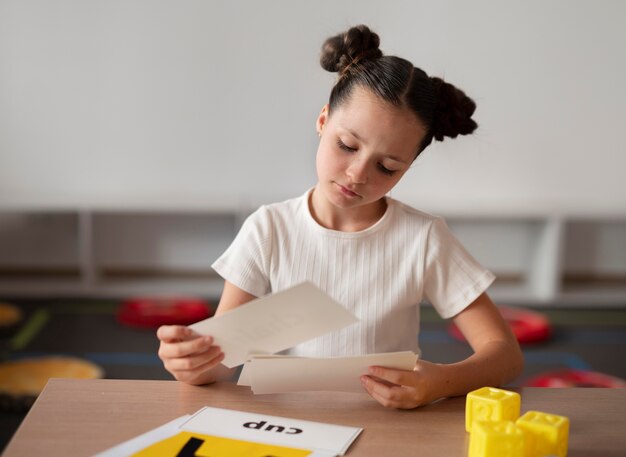 Little girl doing speech therapy at a clinic