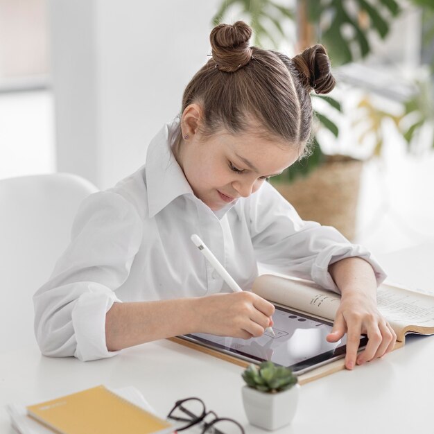 Little girl drawing on her tablet