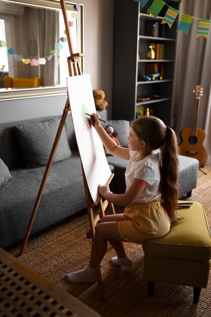 小さな女の子がスタッフで絵を描いている