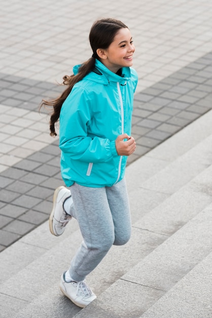 Little girl exercising on stairs