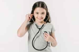 Free photo little girl exploring heartbeat with stethoscope