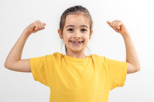 Little girl hand flexing demonstrating biceps isolated on white background