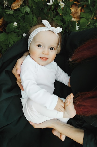 Free photo little girl happy on her mom's hands